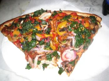 a plate of food with a slice of pizza