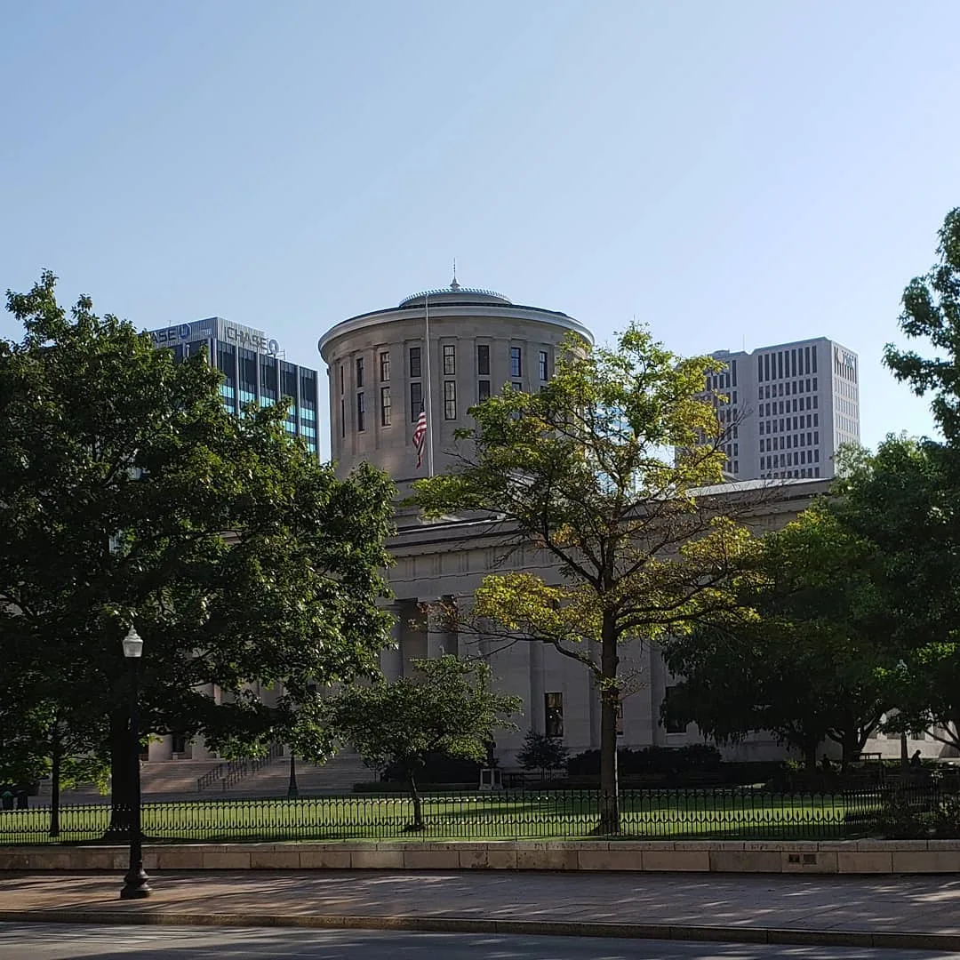 Ohio statehouse with flags at half mast