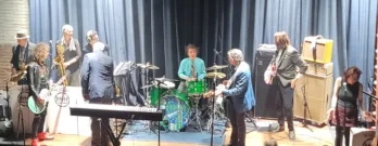 a group of people standing in front of a curtain