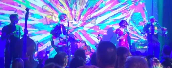 a group of people on a stage in front of a crowd