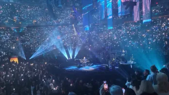 a group of people on a stage in front of a crowd