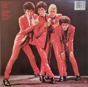 The Romantics posing for a photo in red leather suits