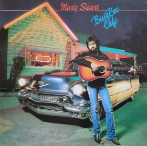 Album Cover: Marty Stuart holding a guitar in front of a 50s care outside a cafe 