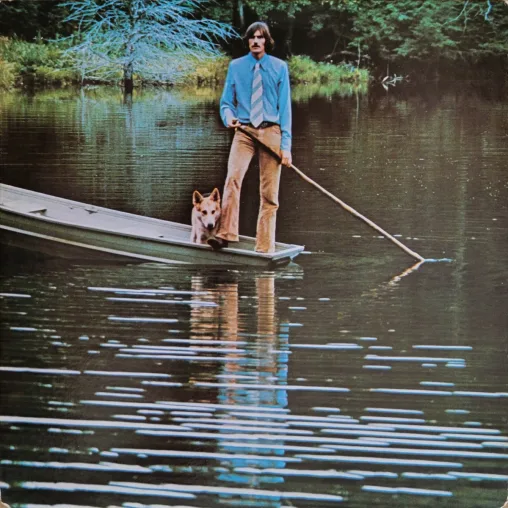 James Taylor in a boat with a dog