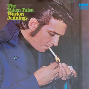 Waylon Jennings lighting a cigarette